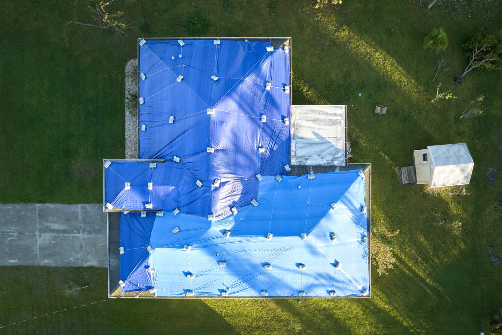 Handnail Roofing team tarping emergency roof damage in The Woodlands TX after storm