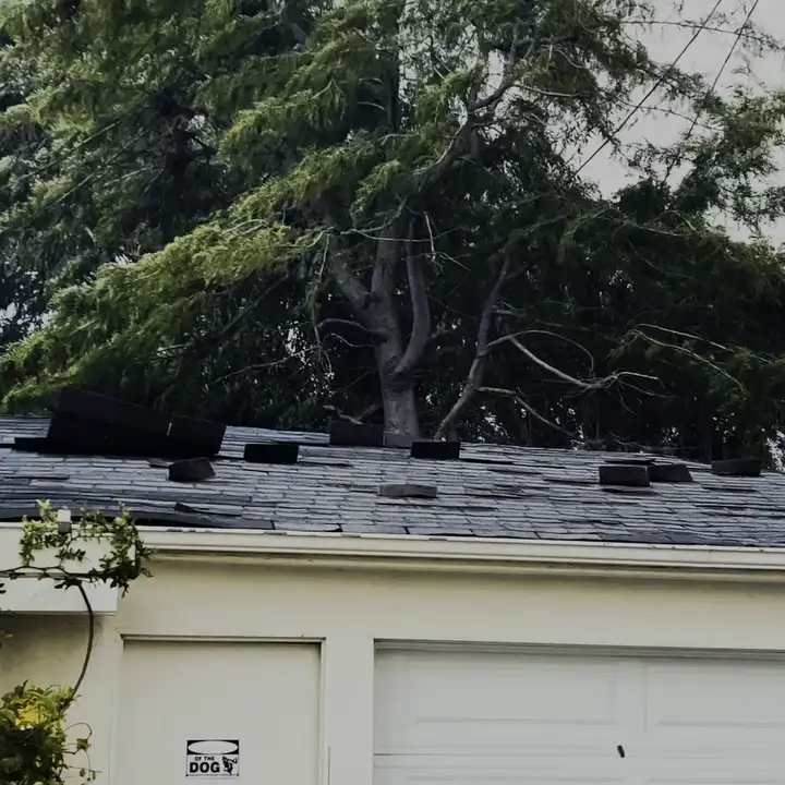 Storm-damaged asphalt shingle roof in Montgomery County before repair by Handnail Roofing